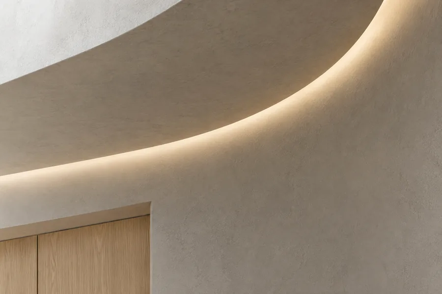 Illustrative curved architectural recess with concealed lighting following the installation route.