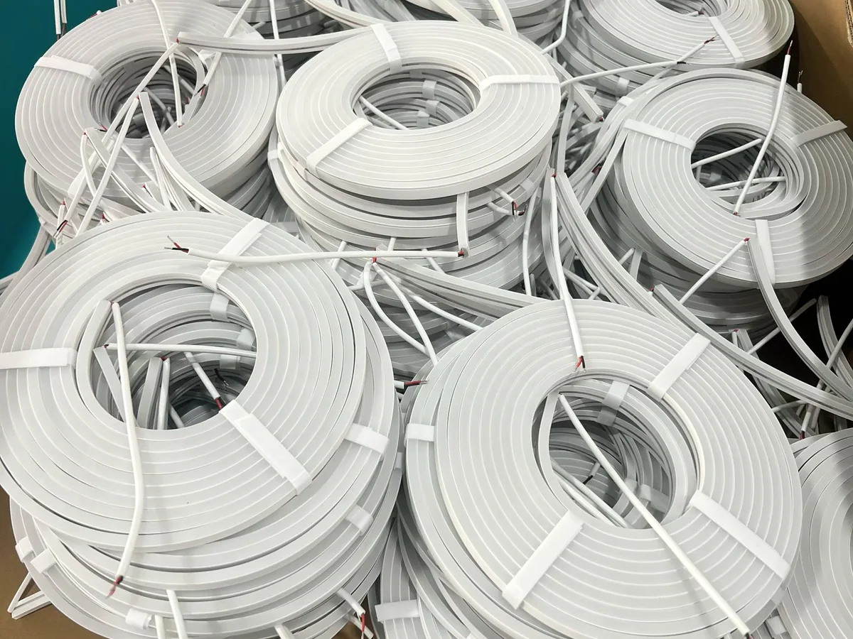 White silicone lighting profiles coiled with power leads