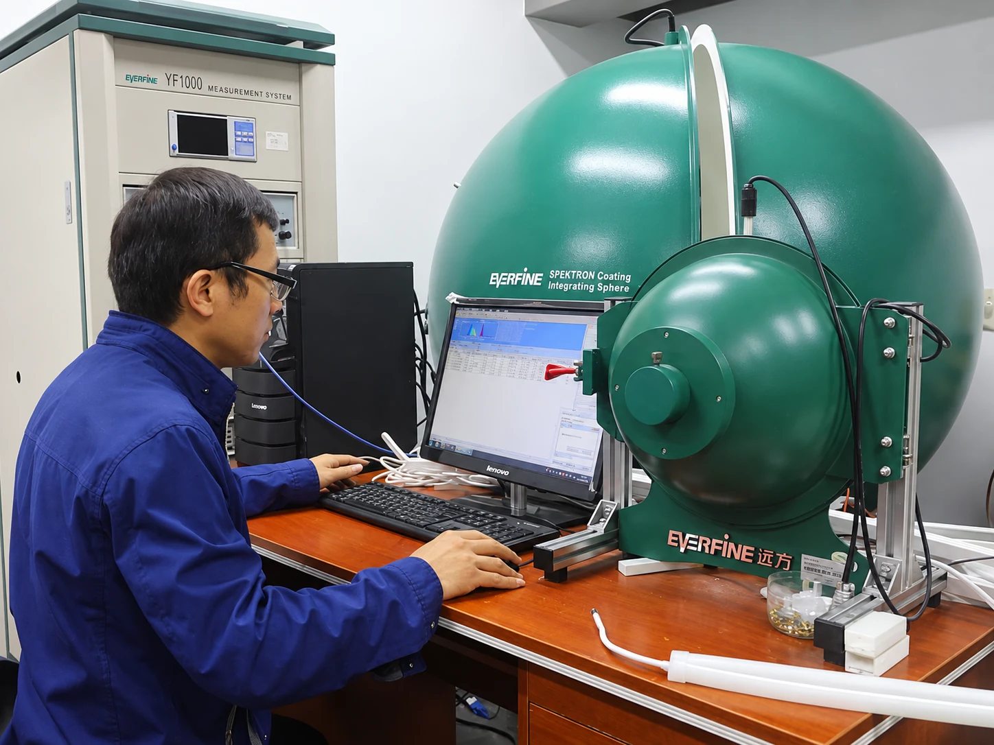 Custom LED Silicone Tube & Profile Manufacturer | AlisterTech Technician operating an integrating sphere measurement system