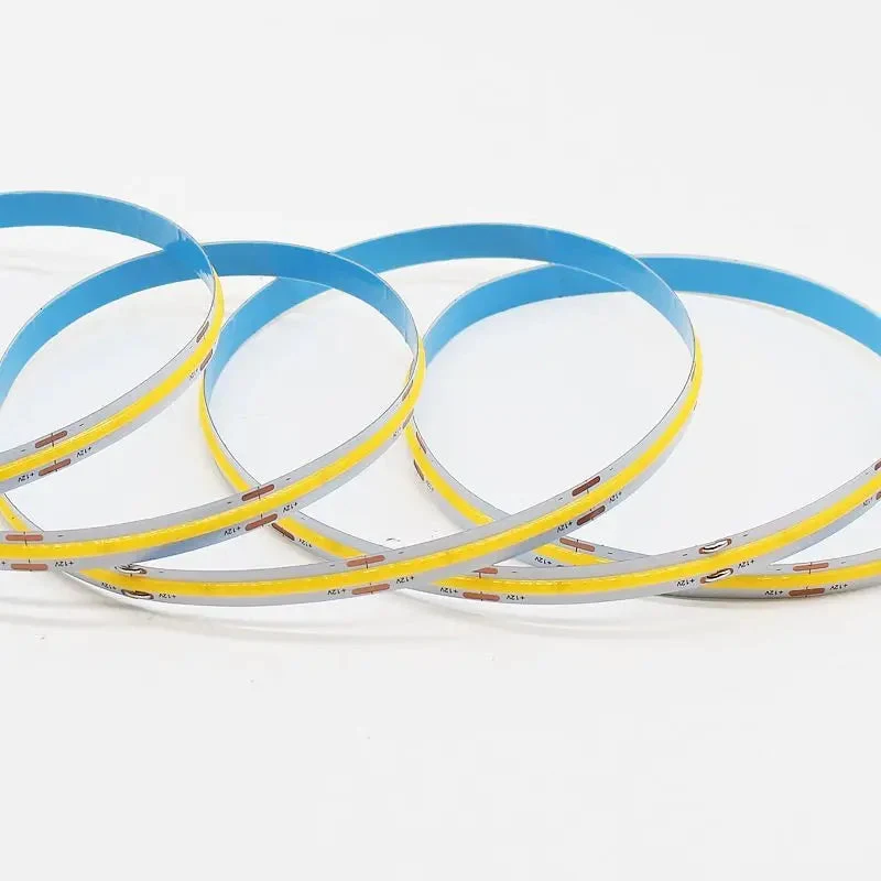 Continuous phosphor-covered surface on a coiled COB LED strip