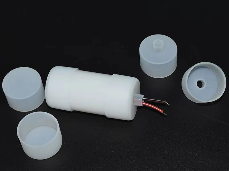 Actual supplied end caps, connector housings and cable parts on a dark background