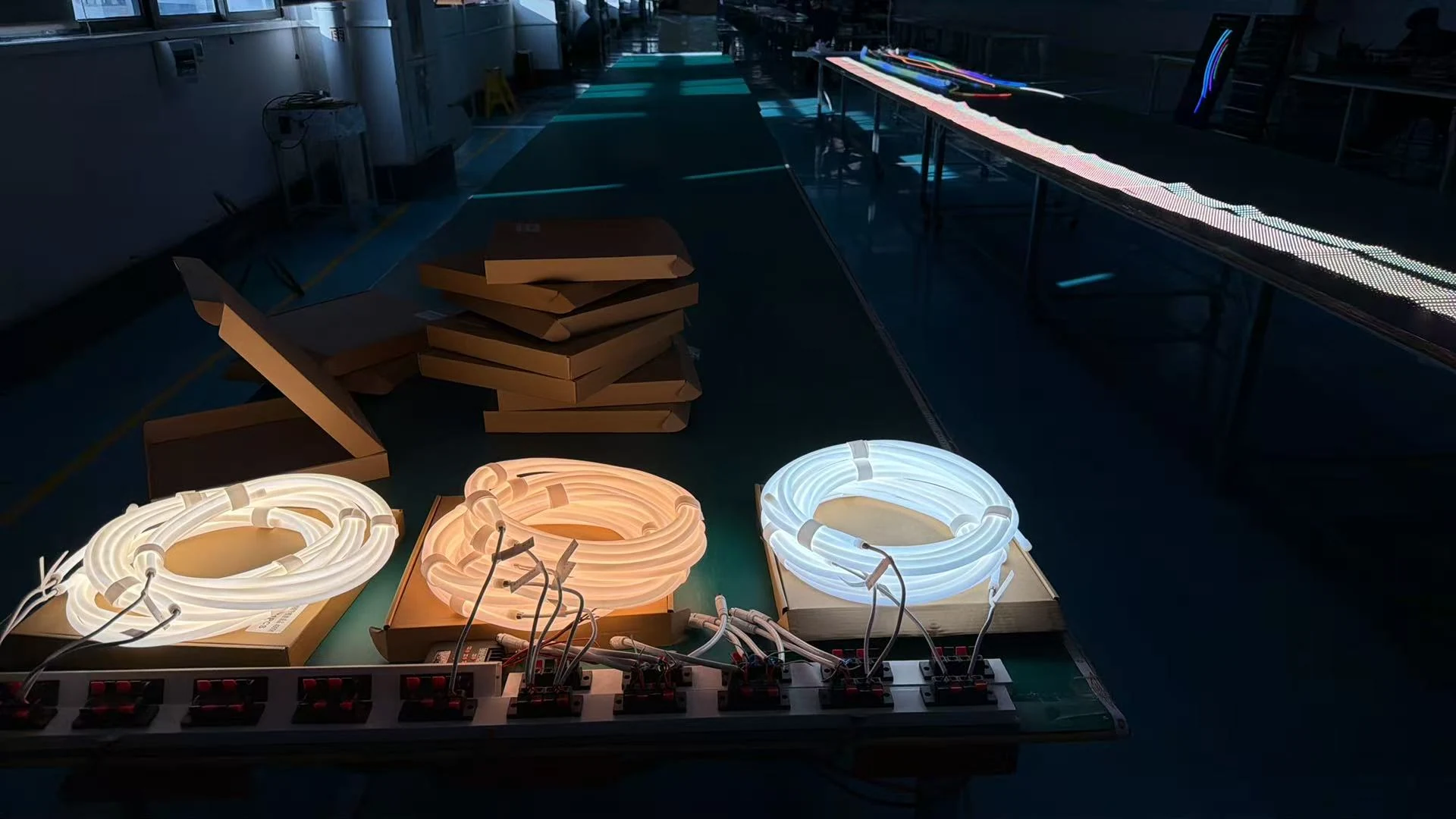 Illuminated silicone lighting samples under review in a production workspace