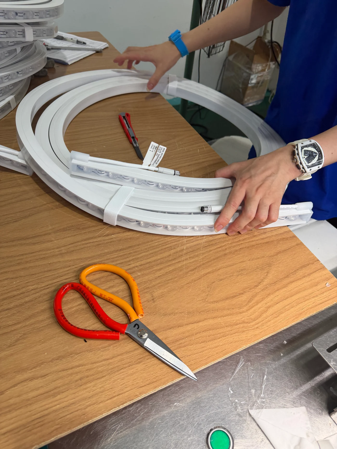 Operator arranging silicone lighting profiles with assembled connections