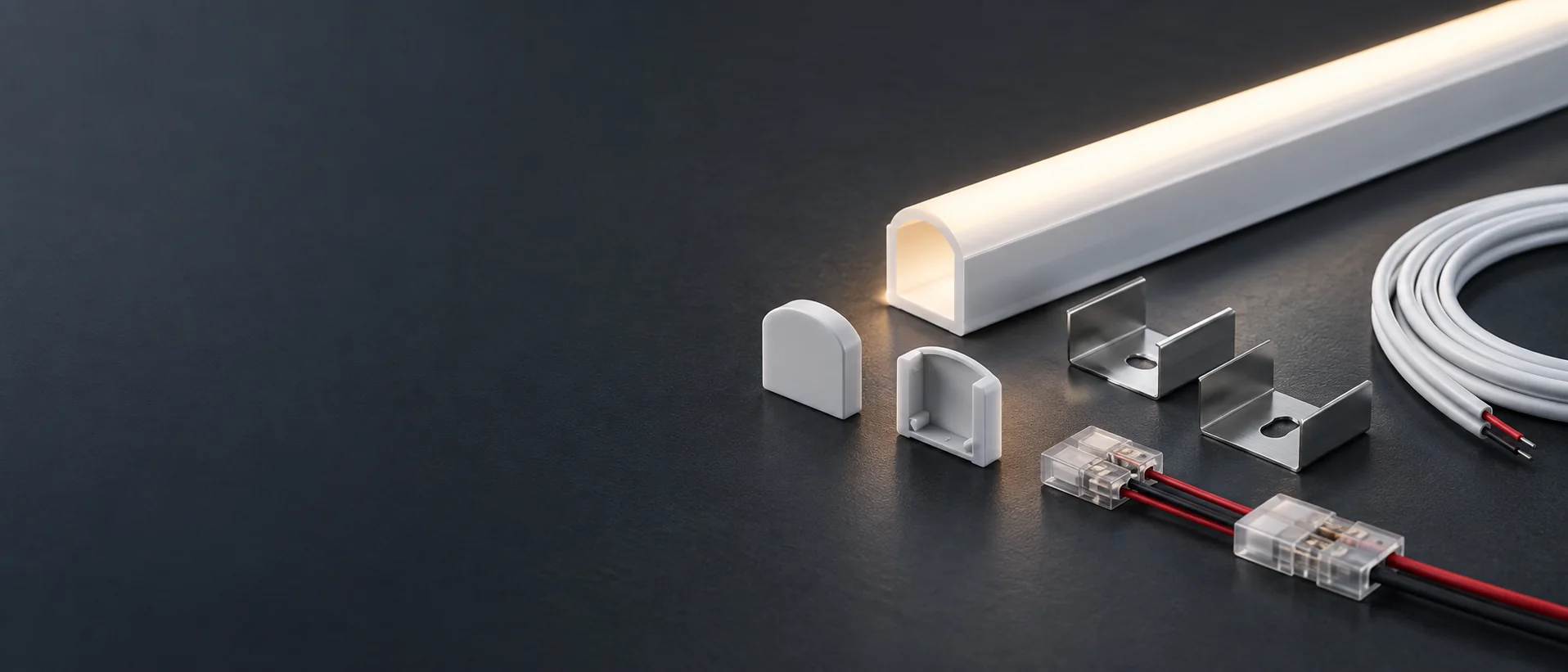 End caps, mounting clips, connectors and cables arranged beside a silicone lighting profile