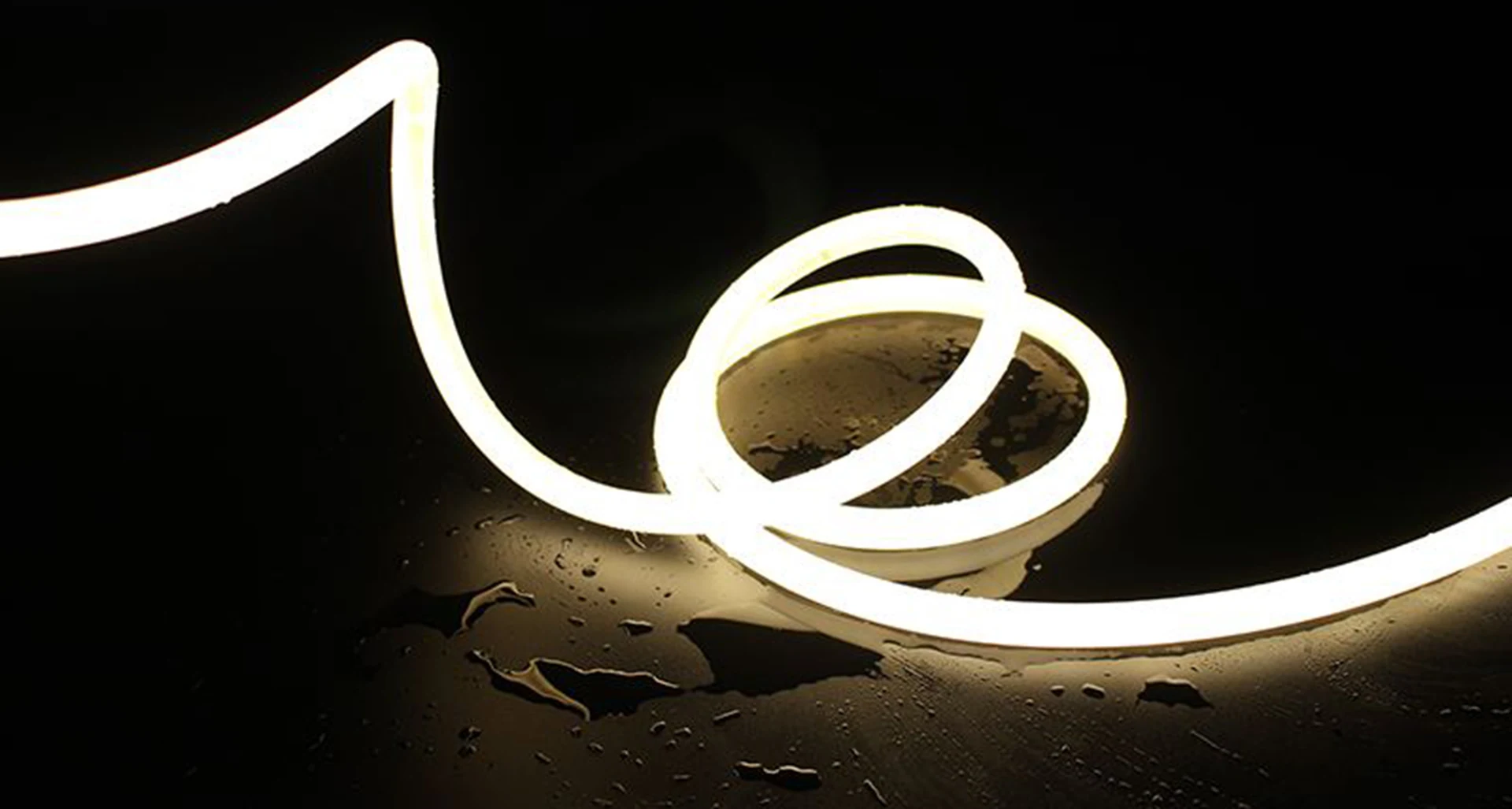 Illuminated flexible LED neon line on a dark surface