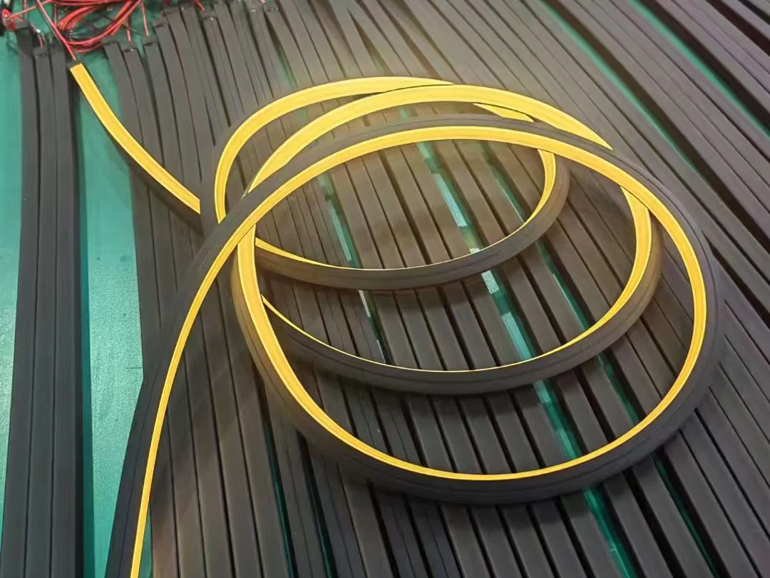 Illuminated LED neon flex arranged in a curved path during production