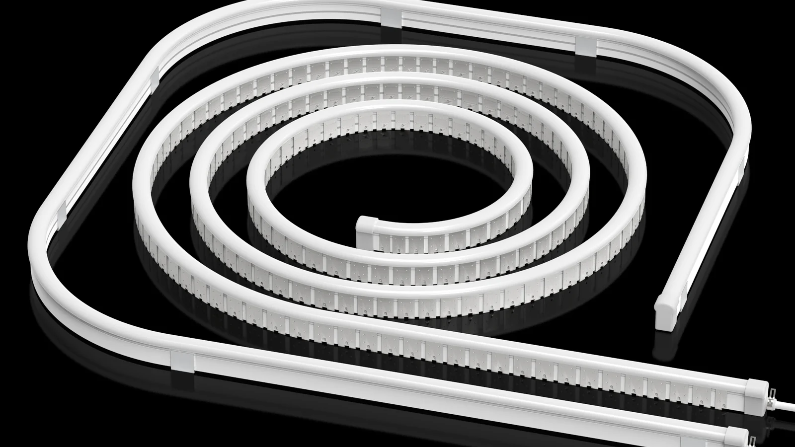 White flexible silicone lighting profiles arranged in curved and straight runs on a dark surface
