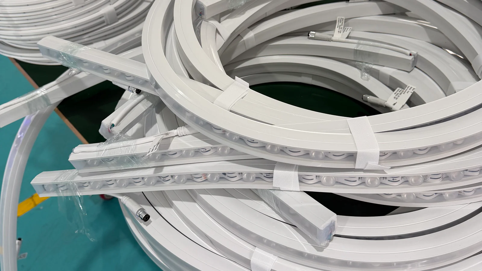 Multiple real silicone lighting profile formats showing different internal LED strip arrangements