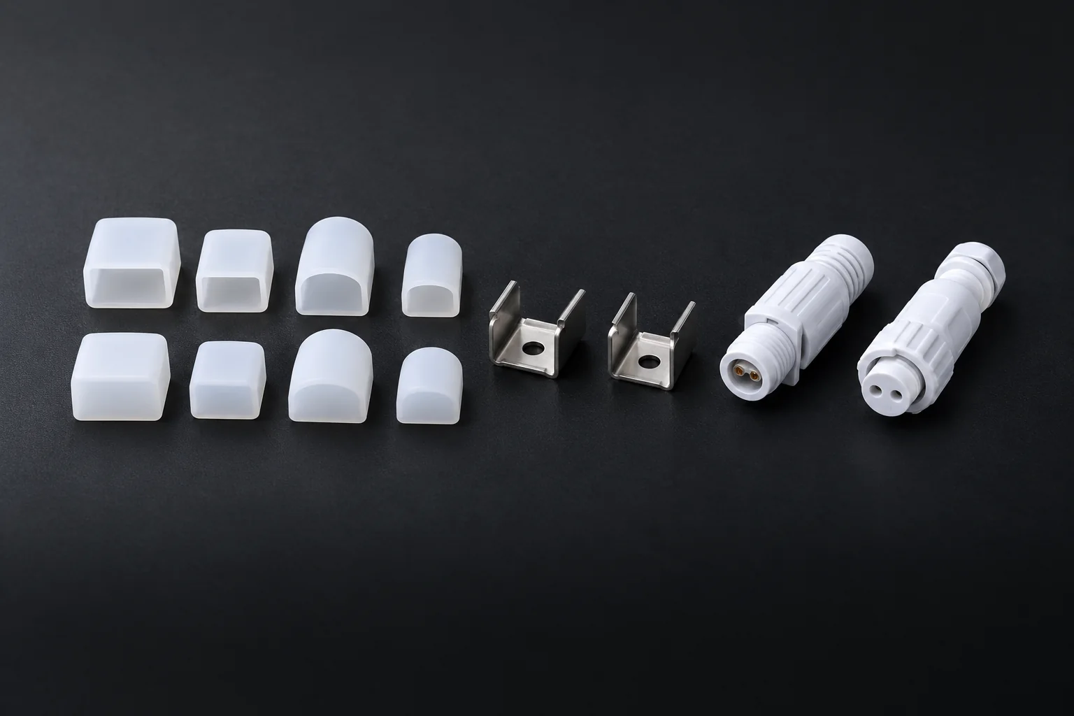 Custom LED Silicone Tube & Profile Manufacturer | AlisterTech Silicone end caps, metal mounting clips and cable connectors arranged as a product set